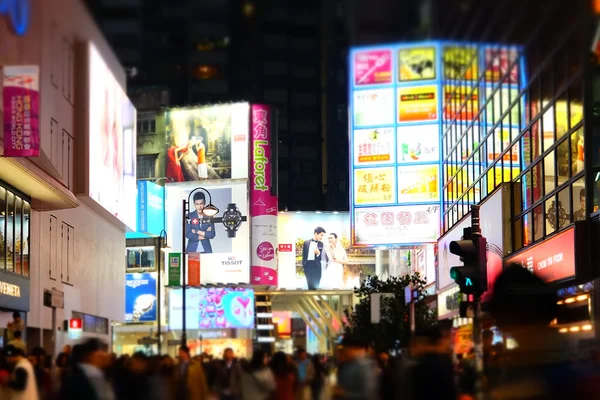 Night view of big sopping mall and people walking at crowded city. Hong Kong