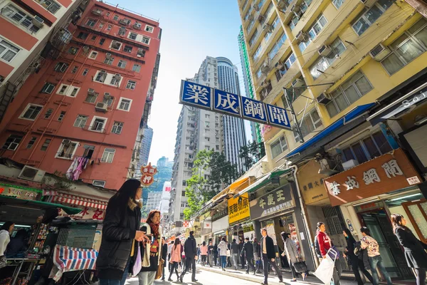 Hong Kong. People walking at crowded streets with skyscrapers