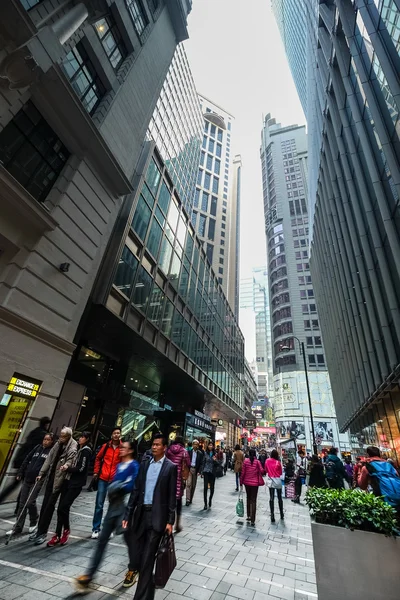 Hong Kong. People walking at crowded streets with skyscrapers