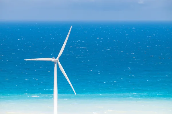 Windmills power generators at ocean coastline. Philippines