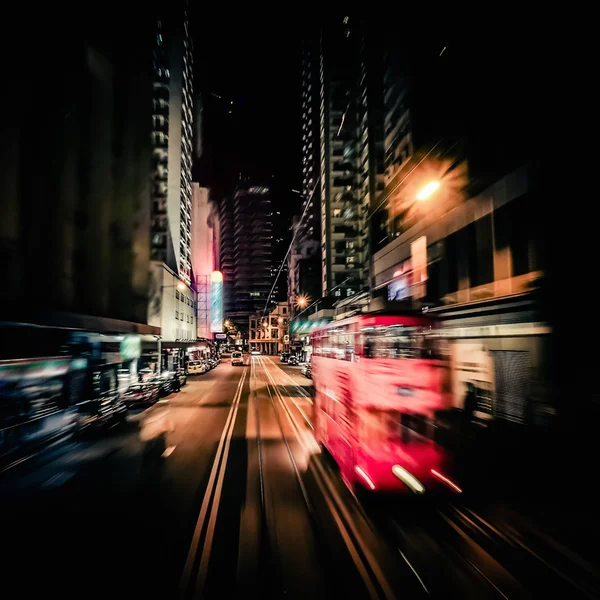 Red tram at modern city street. Motion blur. Hong Kong