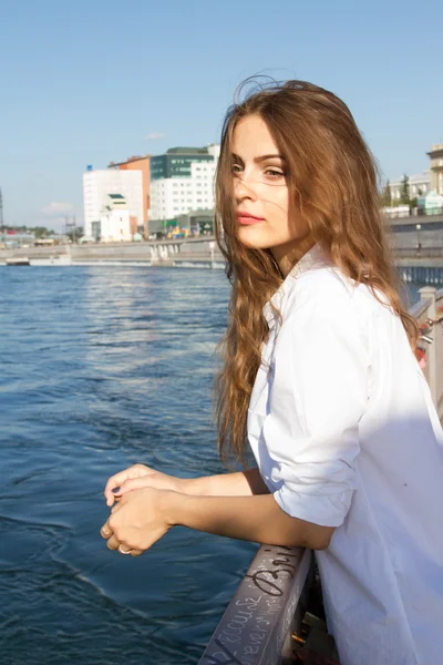 Girl in a white shirt on the embankment of the Angara River in Irkutsk