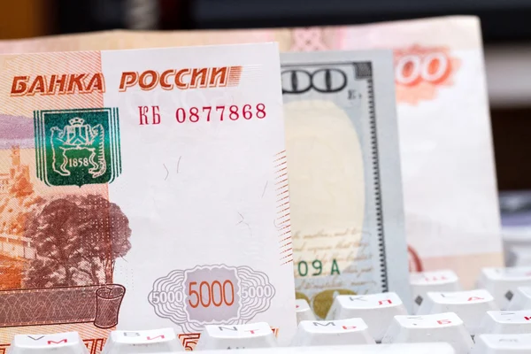Russian rubles and US dollars on a computer keyboard. Wire transfers