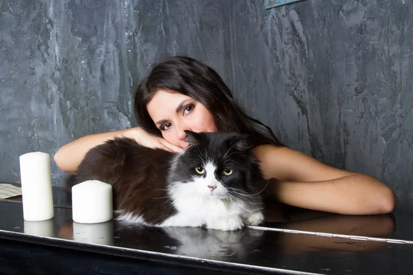 Girl with a cat at the piano