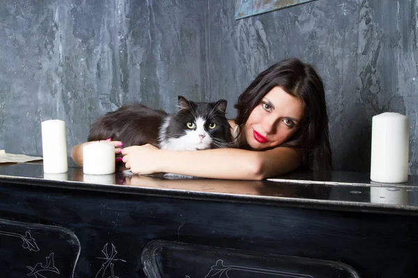 Girl with a cat at the piano