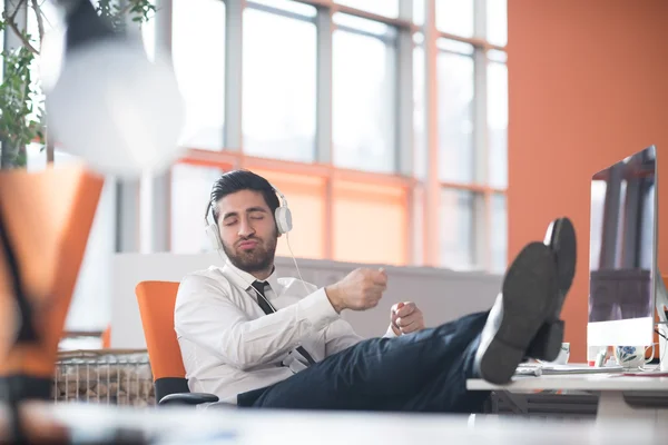 Relaxed young business man at office