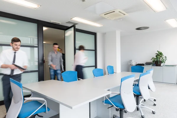 Business people group entering meeting room, motion blur