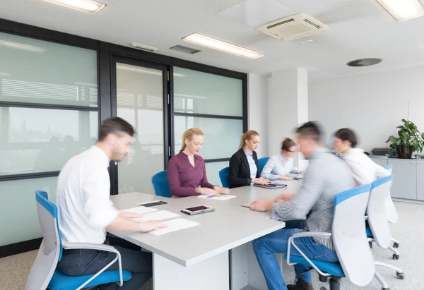 Business people group entering meeting room, motion blur