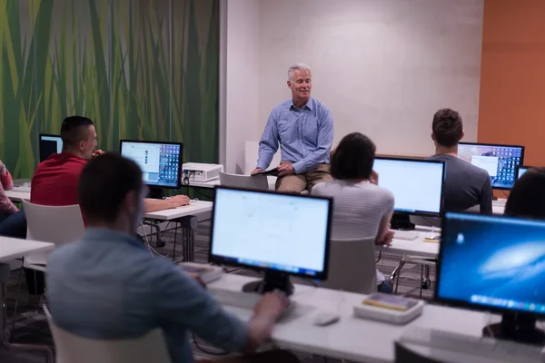 Teacher and students in computer lab classroom