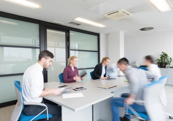 Business people group entering meeting room, motion blur