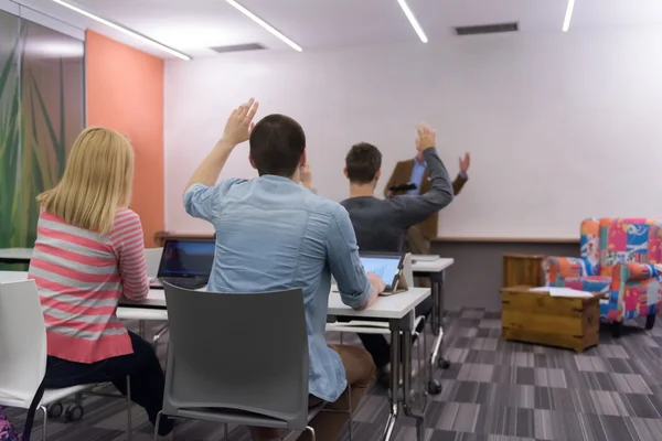 Portrait of in teacher in classroom with students