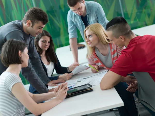 Group of students study together in classroom