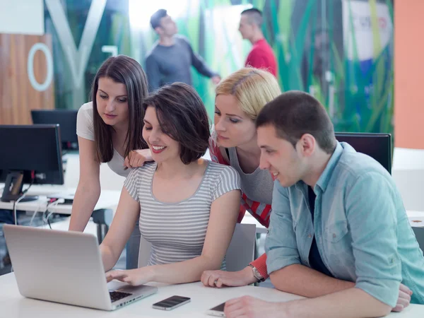 Group of students study together in classroom