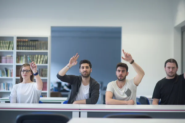 Group of students  raise hands up