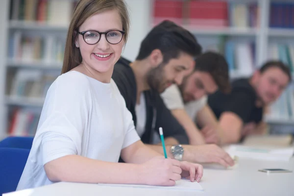 Group of students study together in classroom