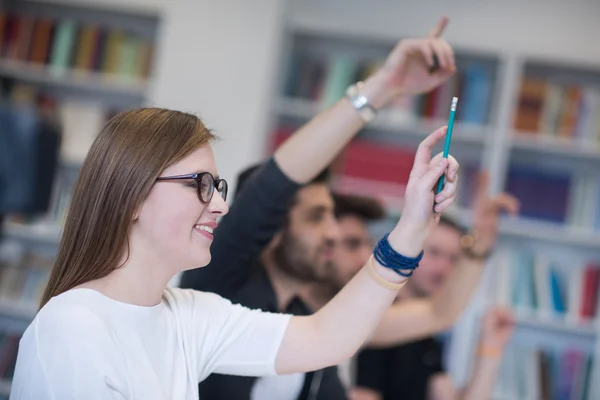 Group of students  raise hands up