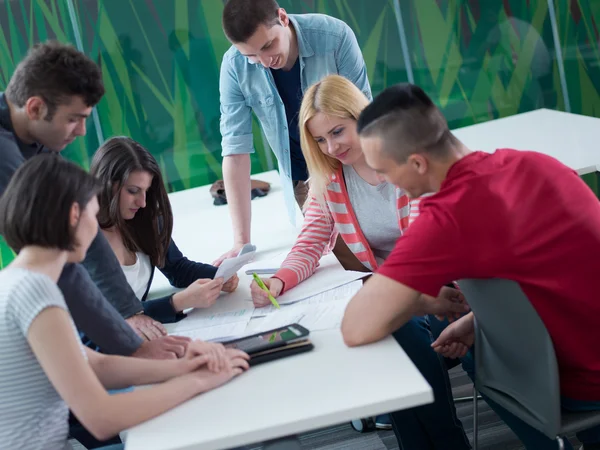 Group of students study together in classroom