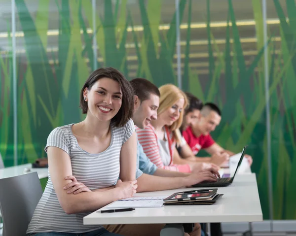 Group of students study together in classroom