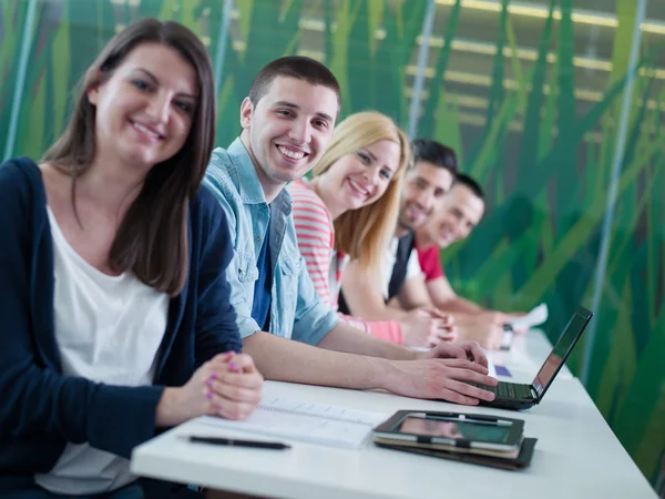 Group of students study together in classroom