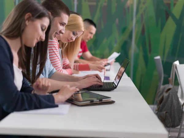 Group of students study together in classroom