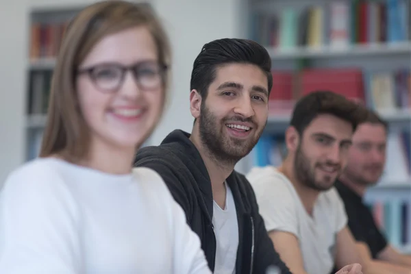 Group of students study together in classroom