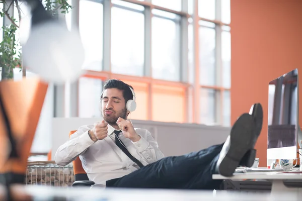 Relaxed young business man at office