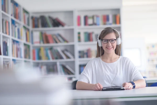 Female student study in library using tablet and searching