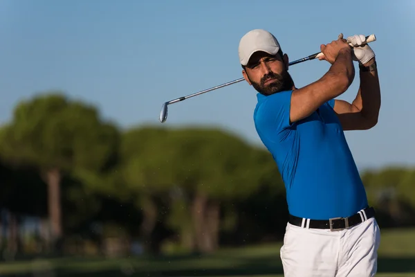 Pro golfer hitting a sand bunker shot