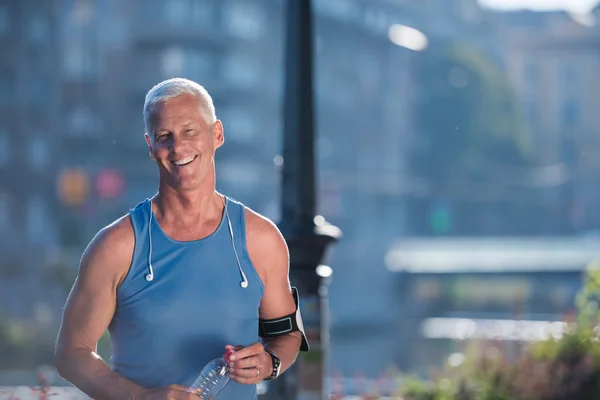 Portrait of handsome senior jogging man