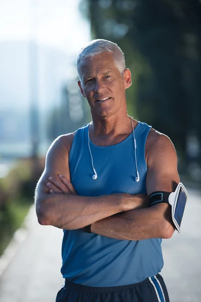 Portrait of handsome senior jogging man