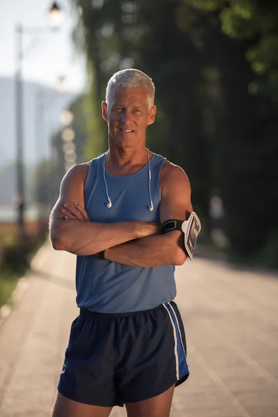 Portrait of handsome senior jogging man