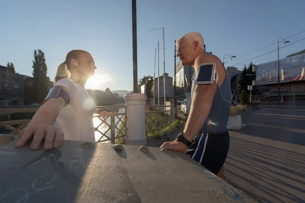 Jogging couple planning running route  and setting music