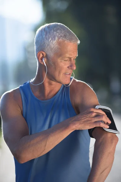 Portrait of handsome senior jogging man