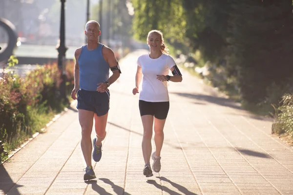 Couple warming up and stretching before jogging