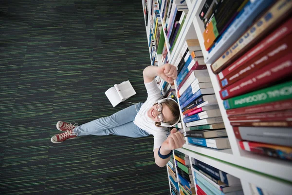 Female student study in library, using tablet and searching for