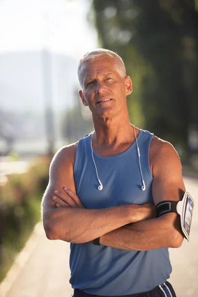 Portrait of handsome senior jogging man