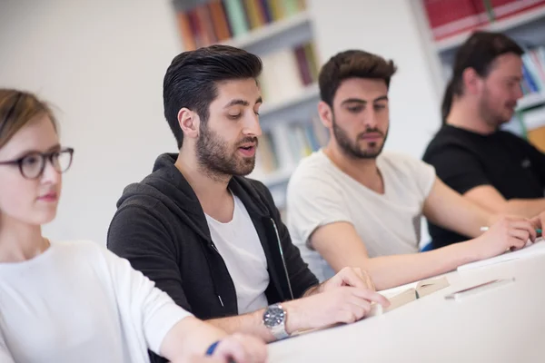 Group of students study together in classroom