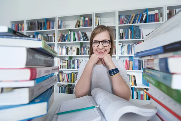 Female student study in library, using tablet