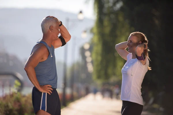 Jogging couple planning running route  and setting music