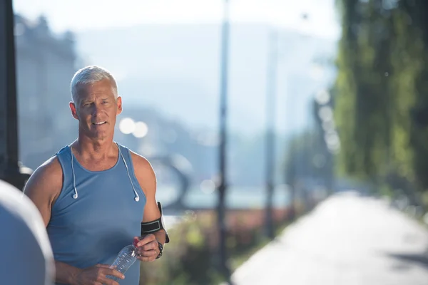 Portrait of handsome senior jogging man