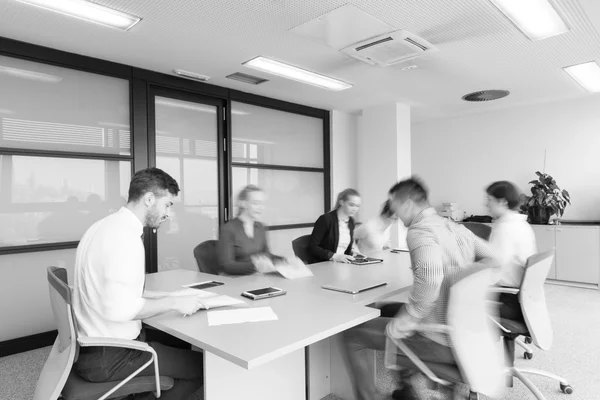 Business people group entering meeting room  motion blur