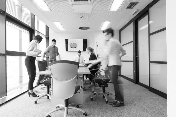 Business people group entering meeting room  motion blur