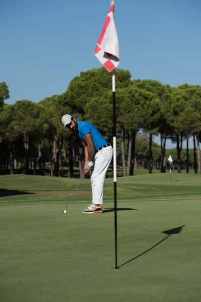 Golf player hitting shot at sunny day