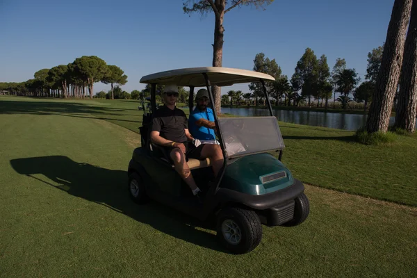 Golf players driving cart at course