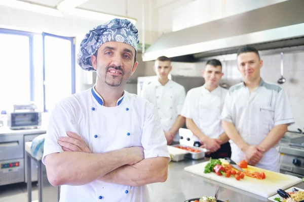 Group of handsome chefs dressed in white uniform