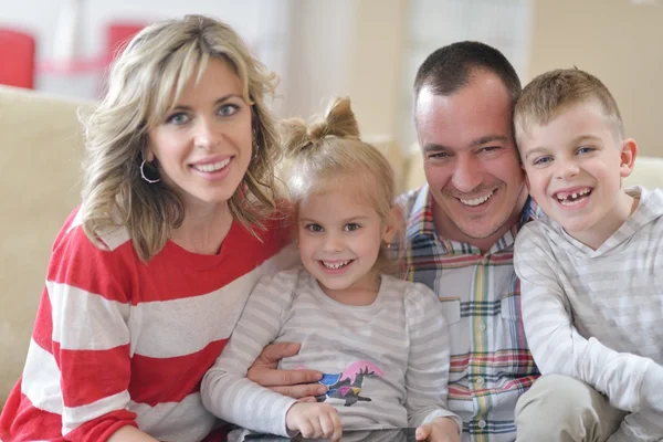 Happy young family at home with tablet computer