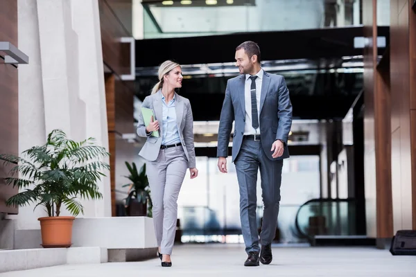 Business man and woman walking