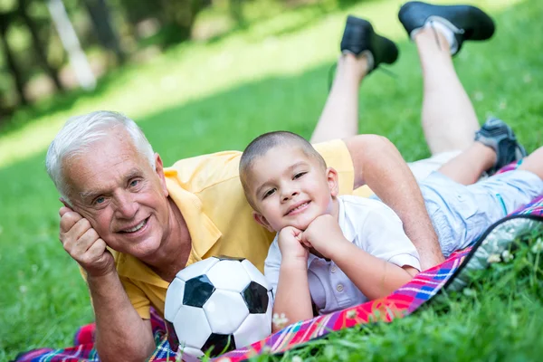 Grandfather and child have fun in park