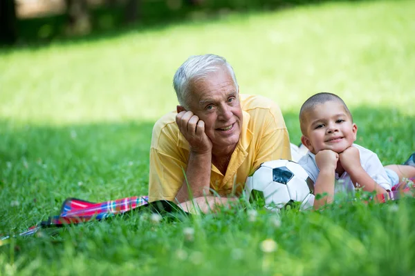 Grandfather and child have fun in park