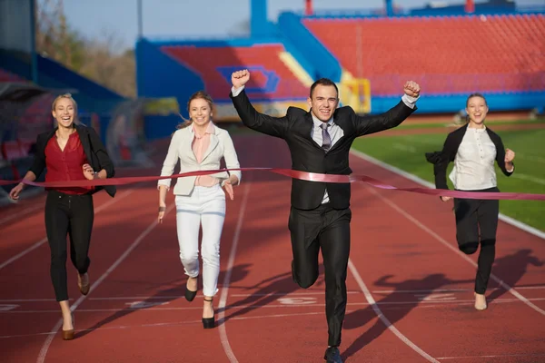 Business people running on racing track